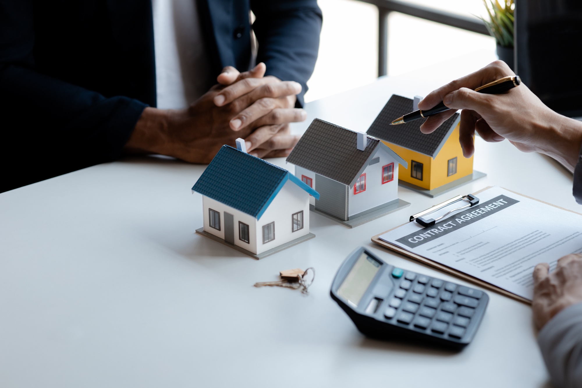 Real estate agents explain models of housing estates in projects.